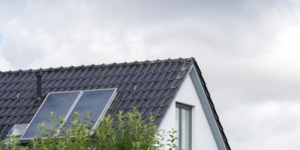 roof with solar panels against dark clouds
